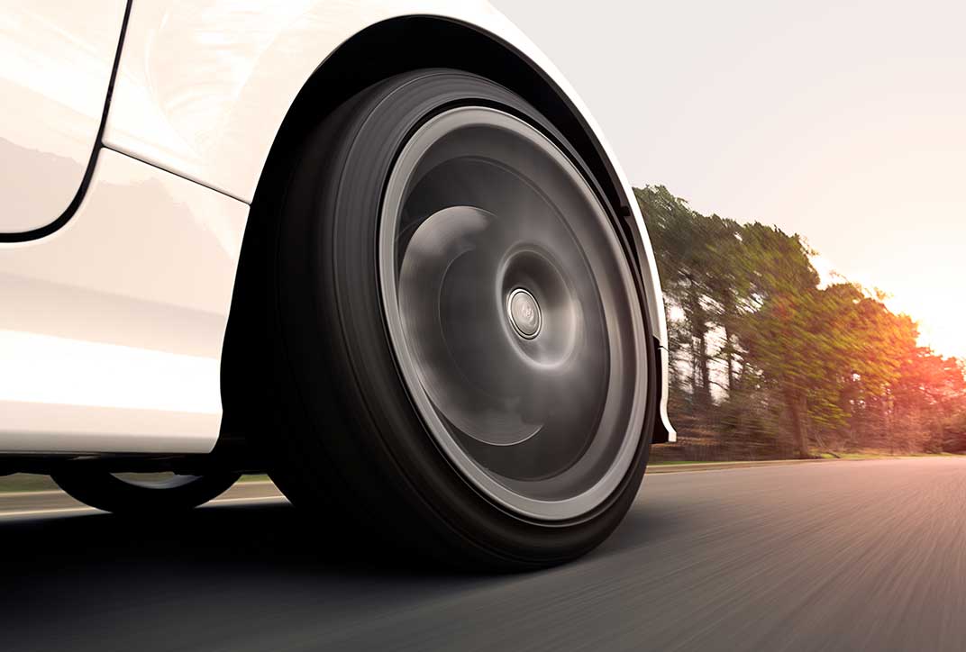 The front tire of a car in motion.