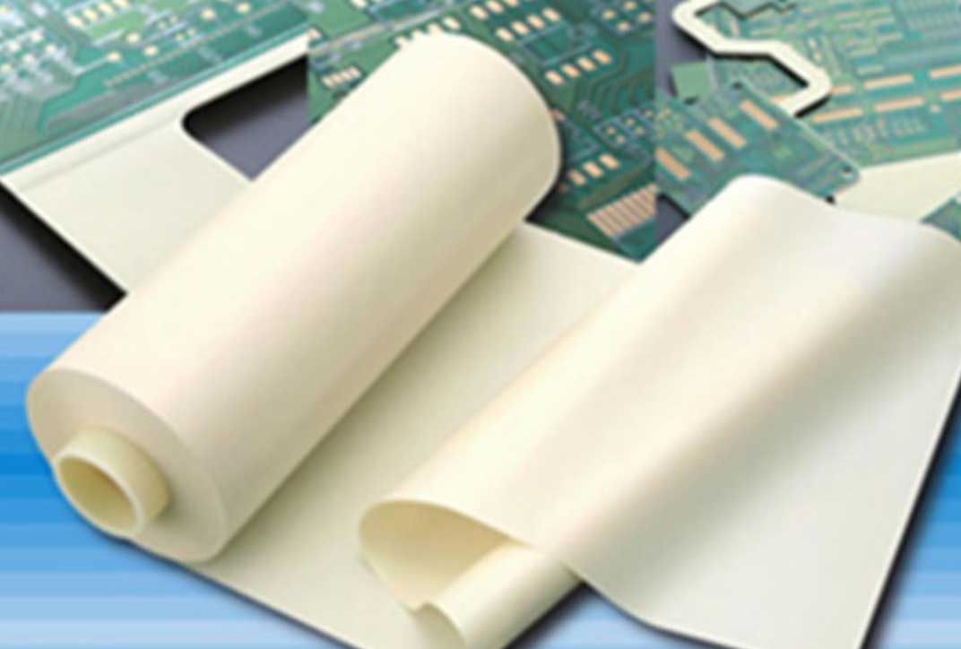 A roll of white film which is partly wound up. It is placed on some circuit boards.