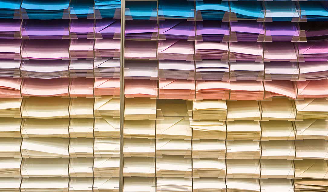 Colorful writing papers and envelopes on the shelves of a stationery store